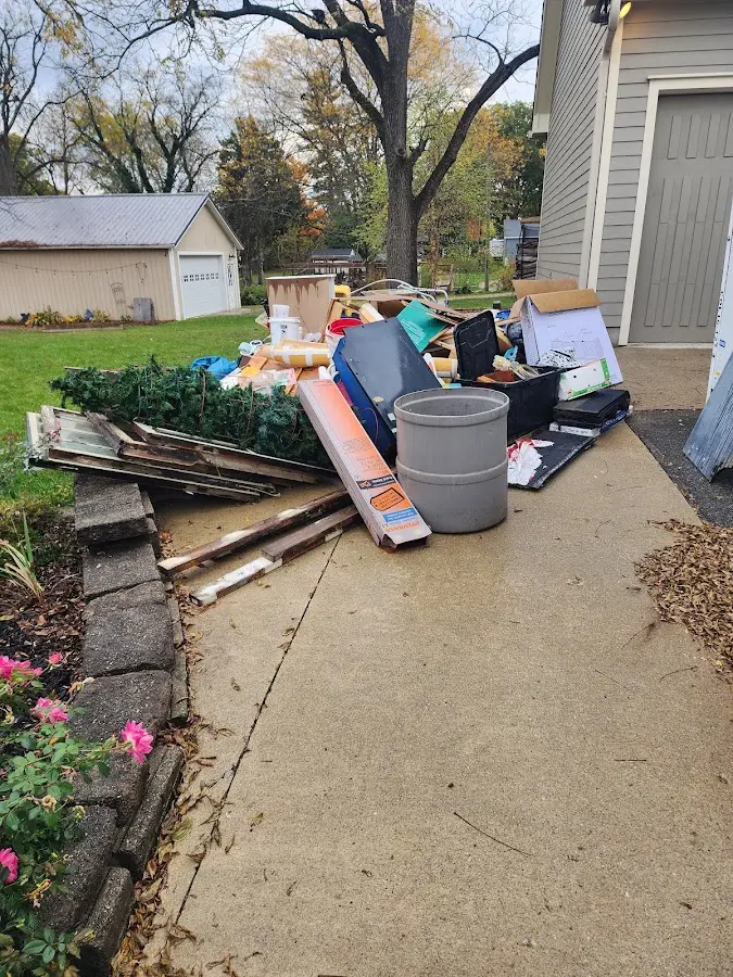 Dumpster being loaded with debris for 12 Yard Dumpster Rental in Oakleaf Plantation